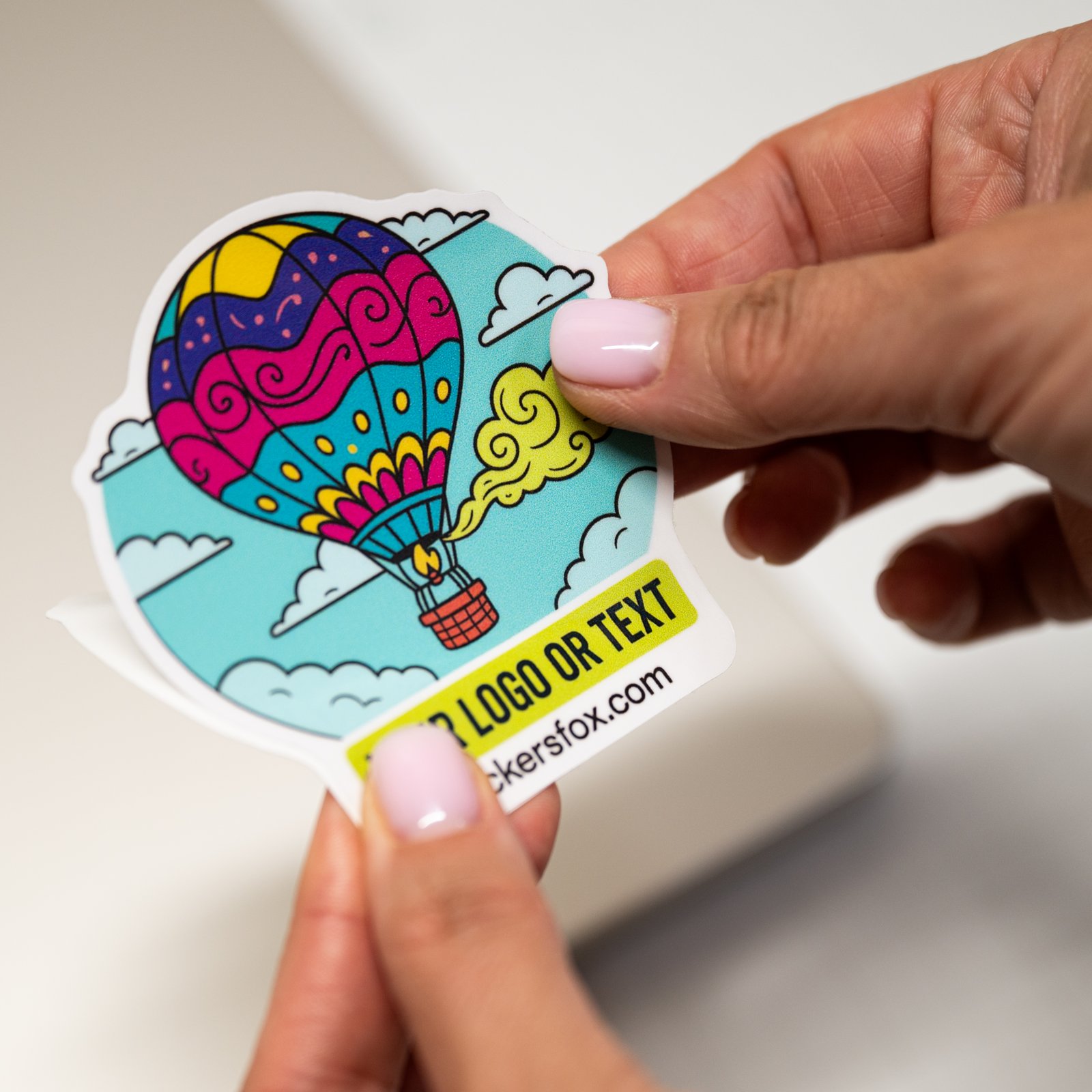 Laminated waterproof vinyl sticker being peeled from its backing